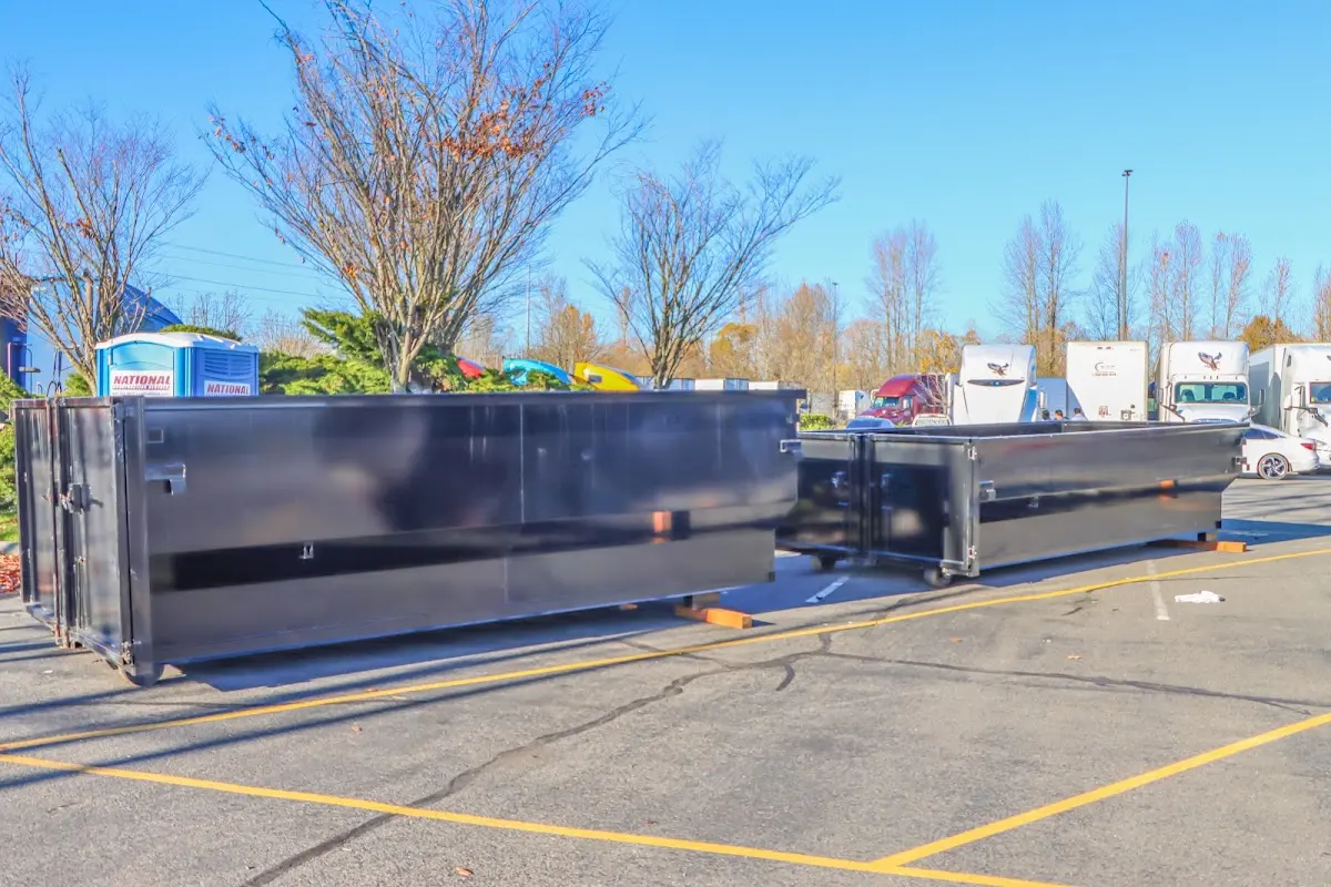 Professional dumpster rental service with roll-off container on residential driveway in Phelan